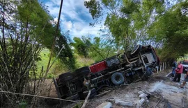 Duas pessoas ficam feridas após caçamba tombar em barranco